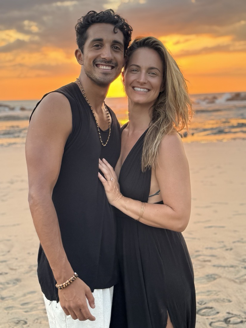 Raj and Natalie on the beach at sunset