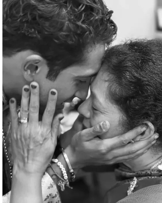 Raj and his mother, foreheads touching, holding each other's faces